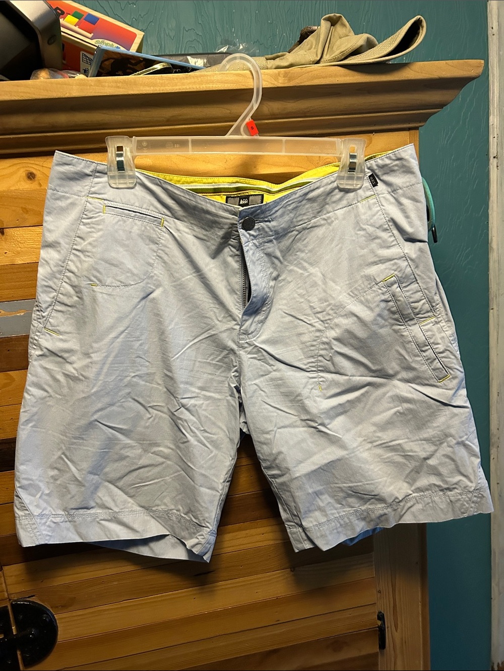 Y2K era woman’s REI shorts in baby blue with yellow stitching.